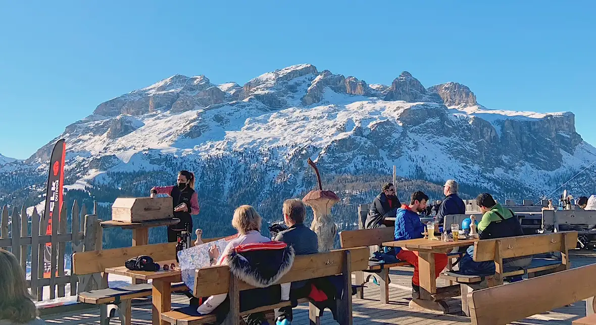 Dolomiti Dinner area, people eating under the mountains